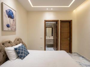 a bedroom with a large bed and a bathroom at Dera October city in 6th Of October