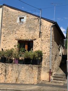 a stone building with a window and a fence at Maison de charme du 18 e s de centre ville in Sablé-sur-Sarthe