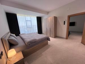 a bedroom with a bed and a television in it at الباحه للشقق المخدومه in Al Baha