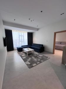 a living room with a couch and a coffee table at الباحه للشقق المخدومه in Al Baha +4 photos