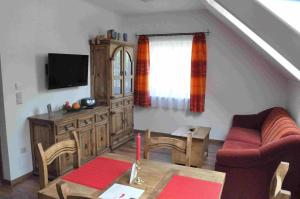 a living room with a couch and a table at Familie Stoier in Reichenau