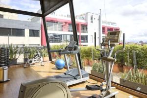 an office with a gym with a large window at Hotel bh Parque 93 in Bogotá +12 photos