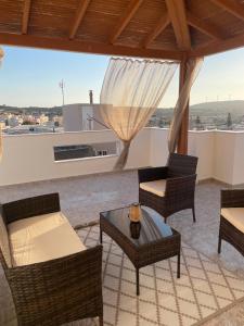 a living room with chairs and a couch and a table at Panora House in Kefalos