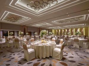 a large banquet room with white tables and chairs at Pullman Jakarta Indonesia in Jakarta +119 photos