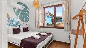 a bedroom with a bed and a window at Casa Fiore in Seferihisar