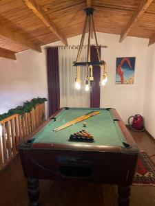 a pool table with cue sticks on top of it at chalet de paradis in Bizerte
