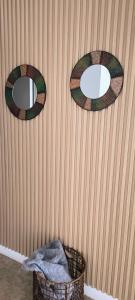 two mirrors on the wall of a room with baskets at CasaMar in General Villegas