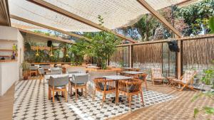 a patio with tables and chairs in a restaurant at Casa Fiore in Seferihisar