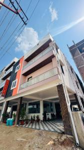 a building with a ladder on the front of it at Arul Rayara Residency in Mādhavaram
