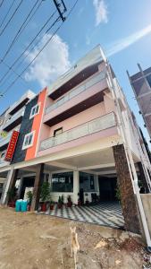 a dog standing in front of a building at Arul Rayara Residency in Mādhavaram +4 photos