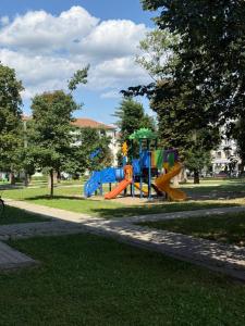 a playground with a slide in a park at Rosu Residence 2 in Onești
