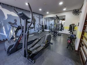 a gym with treadmills and machines in a room at Travel Inn Flats Santo André in Santo André