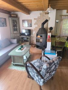 a living room with a couch and a stove at Chata Sandra in Revúca