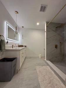 a bathroom with a shower and a sink and a mirror at Clinton Rooms - By Outlets and Beach in Clinton