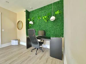 an office with a desk with a computer and a green wall at Clinton Rooms - By Outlets and Beach in Clinton