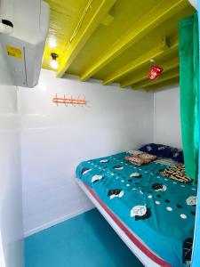 a bunk bed in a bunk room with a blue comforter at Azmy Adventure in Pawenang