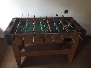 a wooden pool table with avertisementatronatronstrationstrationstrationstrationstration at Chata Leonard in Farná