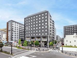 a rendering of a building on a city street at ibis Styles Kyoto Station in Kyoto
