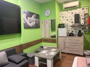 a living room with green walls and a table at Stern in Hückelhoven