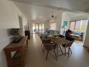a living room with a wooden table and chairs at BnBBonaire near the ocean in Kralendijk