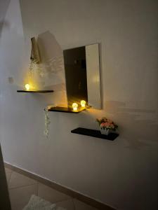 a bathroom with two candles and a mirror on the wall at Harmony serenity studio apartment in Mombasa