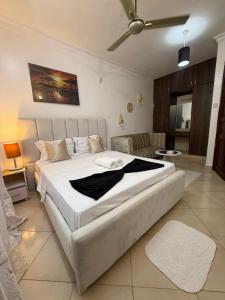 a bedroom with a large white bed in a room at Harmony serenity studio apartment in Mombasa