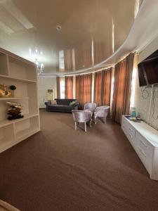 a living room with a couch and a table at MIR Hotel in Türkistan