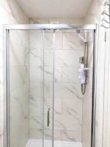 a shower with a glass door in a bathroom at Studio 38 in Leicester