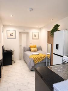 a living room with a bed and a refrigerator at Studio 38 in Leicester