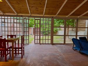 a room with a table and chairs and windows at Los Horneros in Santa María +7 photos