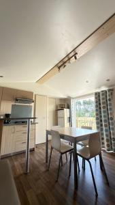 a kitchen with a table and chairs in a room at Casa Apolinario in Ílhavo