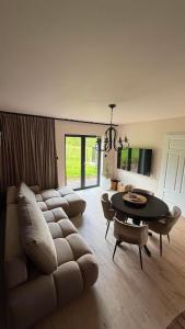 a living room with a couch and a table at Karkonosze pod gwiazdami in Jarkowice