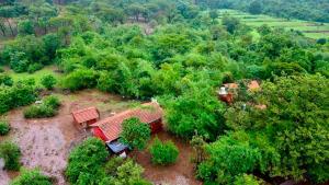 an aerial view of a house in a forest at K Bhoomi Joy by Earth in Bhīra Camp +6 photos