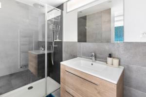 a bathroom with a sink and a shower at Le Bartholdi in Andolsheim +34 photos
