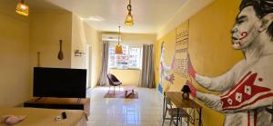 a living room with a large painting on the wall at Tribus Hostel in Manaus