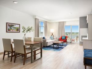 a living room with a dining table and a living room at Compass by Margaritaville Beaufort in Beaufort
