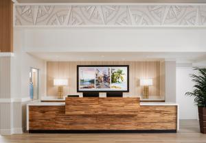 a lobby with a flat screen tv on a wall at Compass by Margaritaville Beaufort in Beaufort