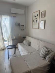 a living room with a couch and a table at Moderna Yaya - Andros Chora in Andros