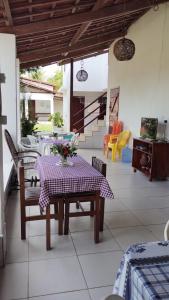 a patio with a table with a purple table cloth at Casa Luna in Marau +9 photos