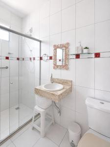 a bathroom with a sink and a shower and a toilet at Casa Luna in Marau