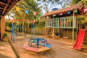a playground with a bunch of slides and swings at Aconchego Caminho das Cachoeiras in Rio Acima