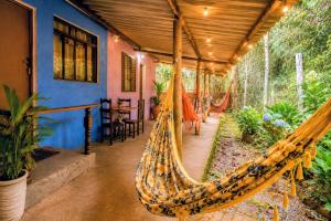 a hammock on a porch of a house at Aconchego Caminho das Cachoeiras in Rio Acima