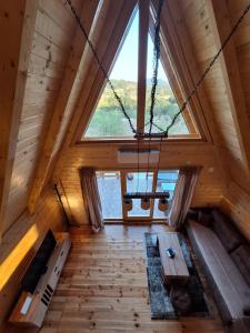 a room with a large window in a cabin at Brvnara kao na dlanu 2 in Rudnik +9 photos