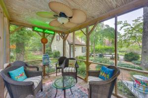 a screened porch with chairs and a ceiling fan at Pool Access! Cozy Couple's Getaway in Kilmarnock in Kilmarnock