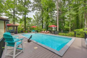 a swimming pool with two chairs and a table at Pool Access! Cozy Couple's Getaway in Kilmarnock in Kilmarnock