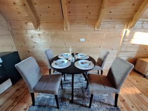 a dining room with a black table and chairs at Brvnara kao na dlanu 2 in Rudnik