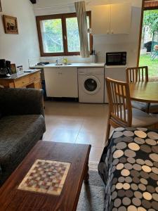 a living room with a couch and a table at Studio climatisé in Paray-Vieille-Poste