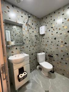 a bathroom with a white toilet and a sink at Ninika B&B Utsera in Oni +32 photos