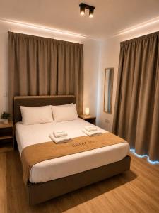 a bedroom with a large bed in a room at Valentino By ERMASS ex Valentinos Apts in Paphos