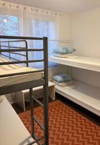 a room with three bunk beds and a window at Welcome Home in Piaseczno +4 photos